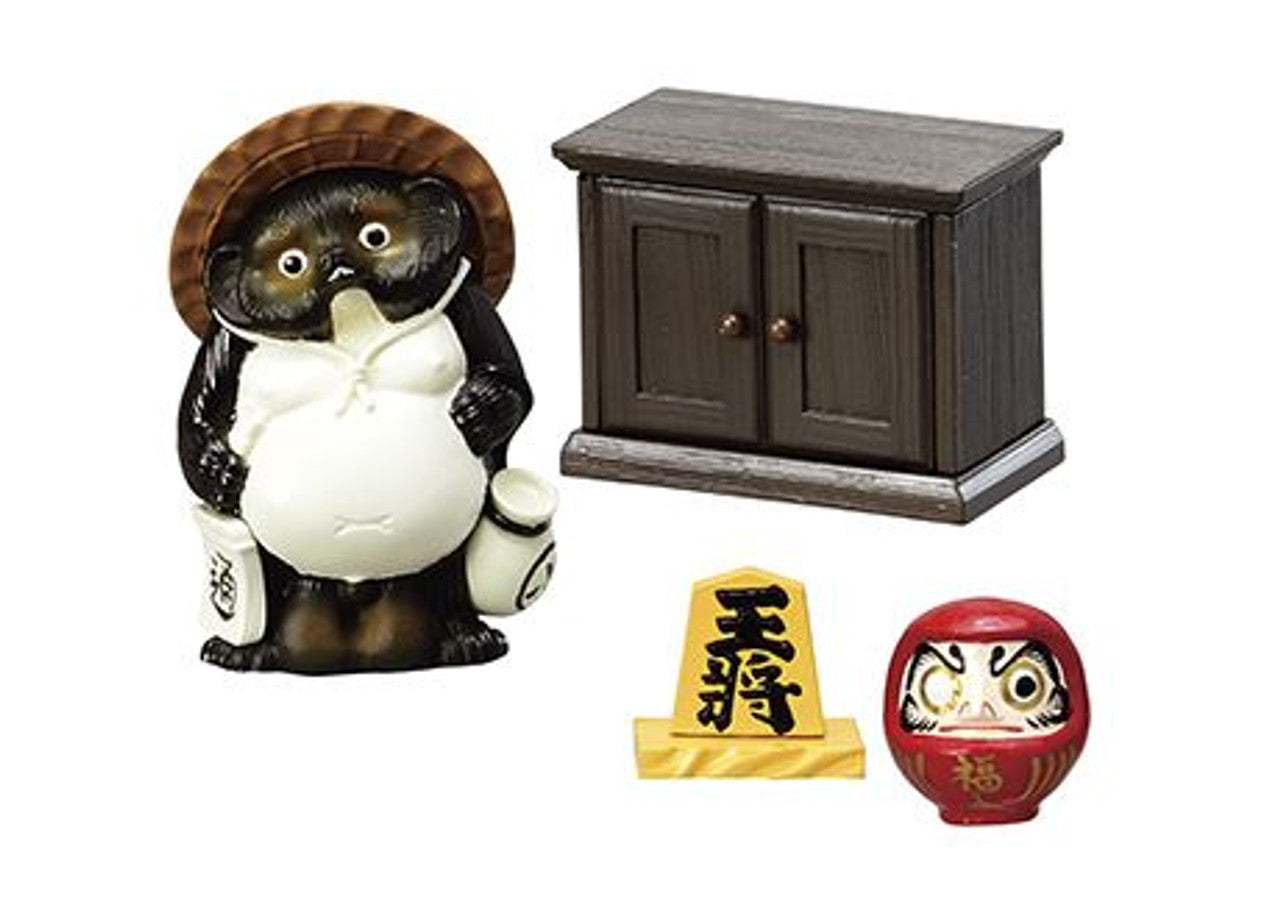 Set of small decorative items including a cat figurine, cabinet, and two other small objects on a white background