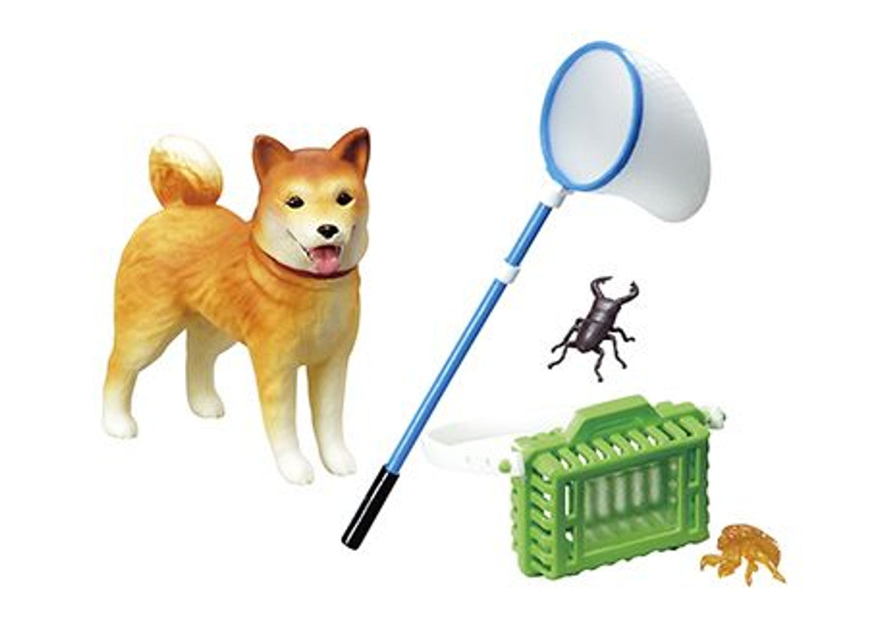 Toy dog with a net, crate, and toy insect on a white background