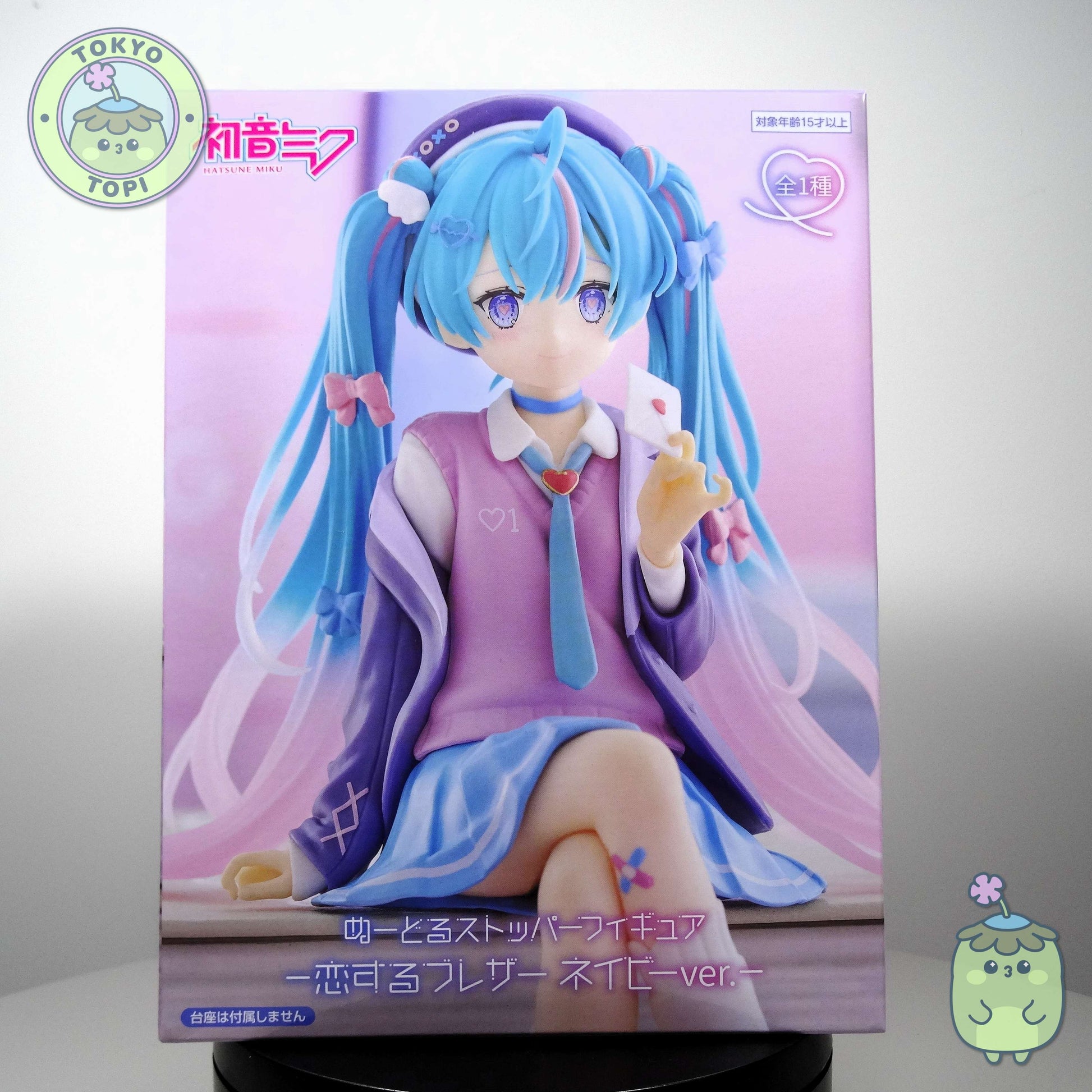 This charming Noodle Stopper captures Hatsune Miku in her iconic Blazer in Love Navy outfit. Standing approximately 14cm tall, the figure showcases meticulous craftsmanship with carefully rendered details across her distinctive hair and delicate leg tattoo. The pink and blue colour palette perfectly complements the character's signature aesthetic, making it an essential addition for devoted collectors and fans of the beloved virtual idol.