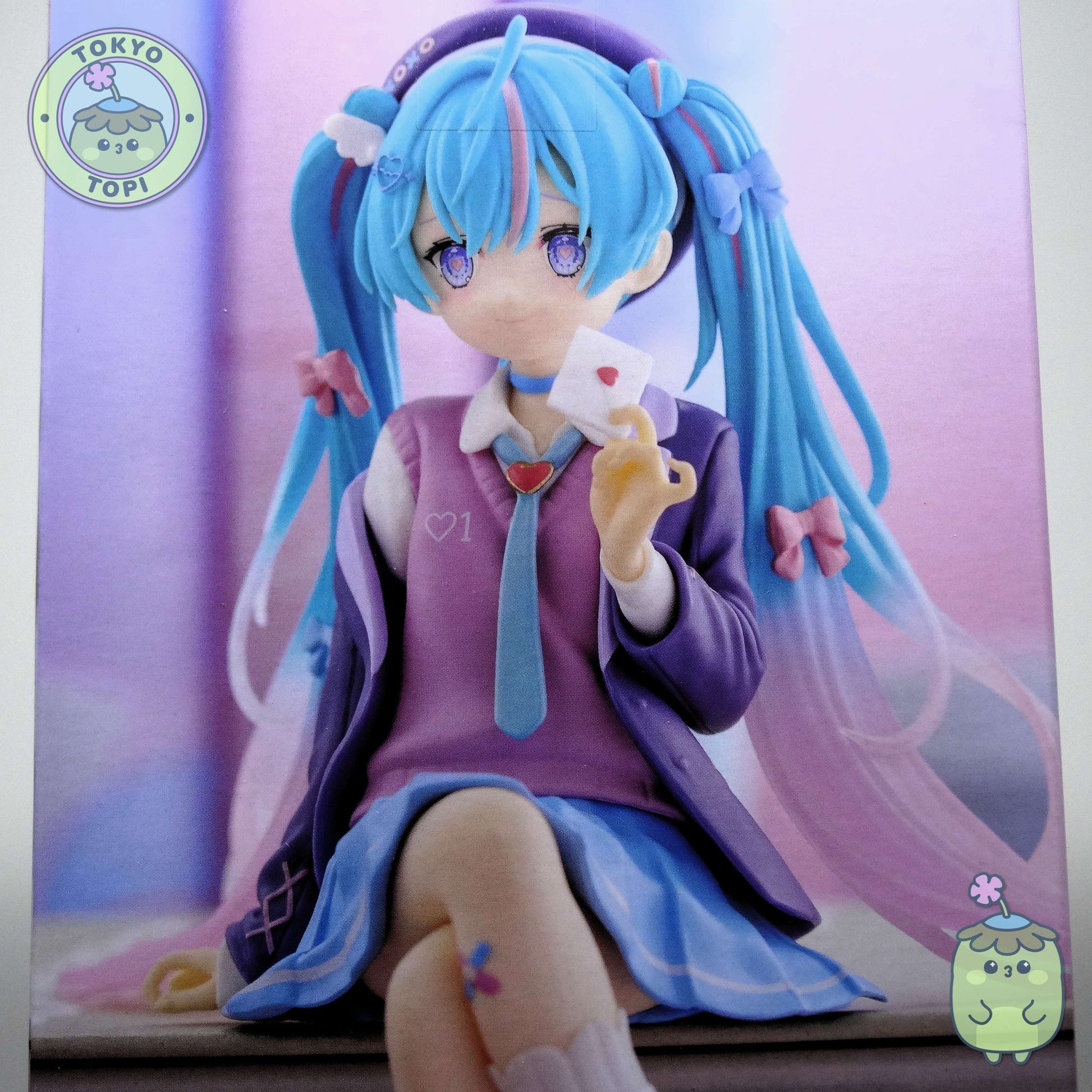 This charming Noodle Stopper captures Hatsune Miku in her iconic Blazer in Love Navy outfit. Standing approximately 14cm tall, the figure showcases meticulous craftsmanship with carefully rendered details across her distinctive hair and delicate leg tattoo. The pink and blue colour palette perfectly complements the character's signature aesthetic, making it an essential addition for devoted collectors and fans of the beloved virtual idol.