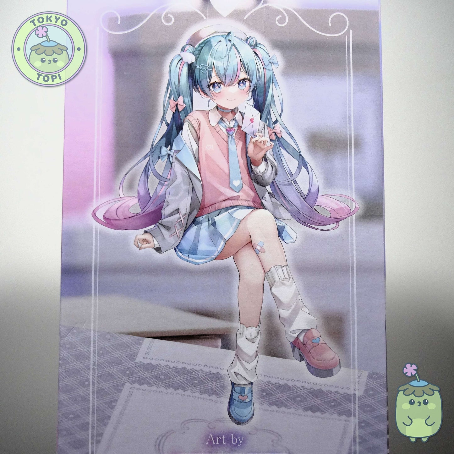 This charming Noodle Stopper captures Hatsune Miku in her iconic Blazer in Love Navy outfit. Standing approximately 14cm tall, the figure showcases meticulous craftsmanship with carefully rendered details across her distinctive hair and delicate leg tattoo. The pink and blue colour palette perfectly complements the character's signature aesthetic, making it an essential addition for devoted collectors and fans of the beloved virtual idol.