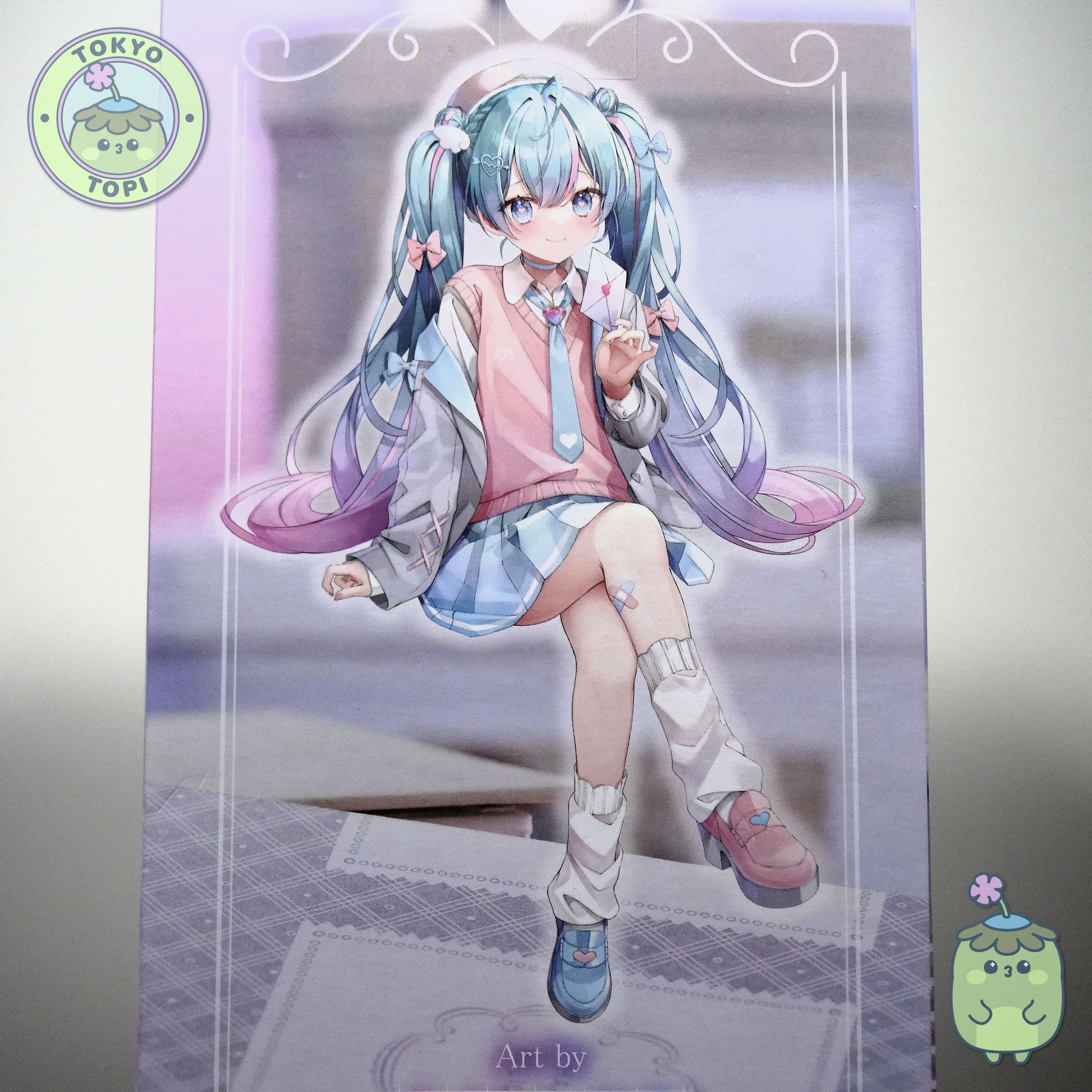 This charming Noodle Stopper captures Hatsune Miku in her iconic Blazer in Love Navy outfit. Standing approximately 14cm tall, the figure showcases meticulous craftsmanship with carefully rendered details across her distinctive hair and delicate leg tattoo. The pink and blue colour palette perfectly complements the character's signature aesthetic, making it an essential addition for devoted collectors and fans of the beloved virtual idol.