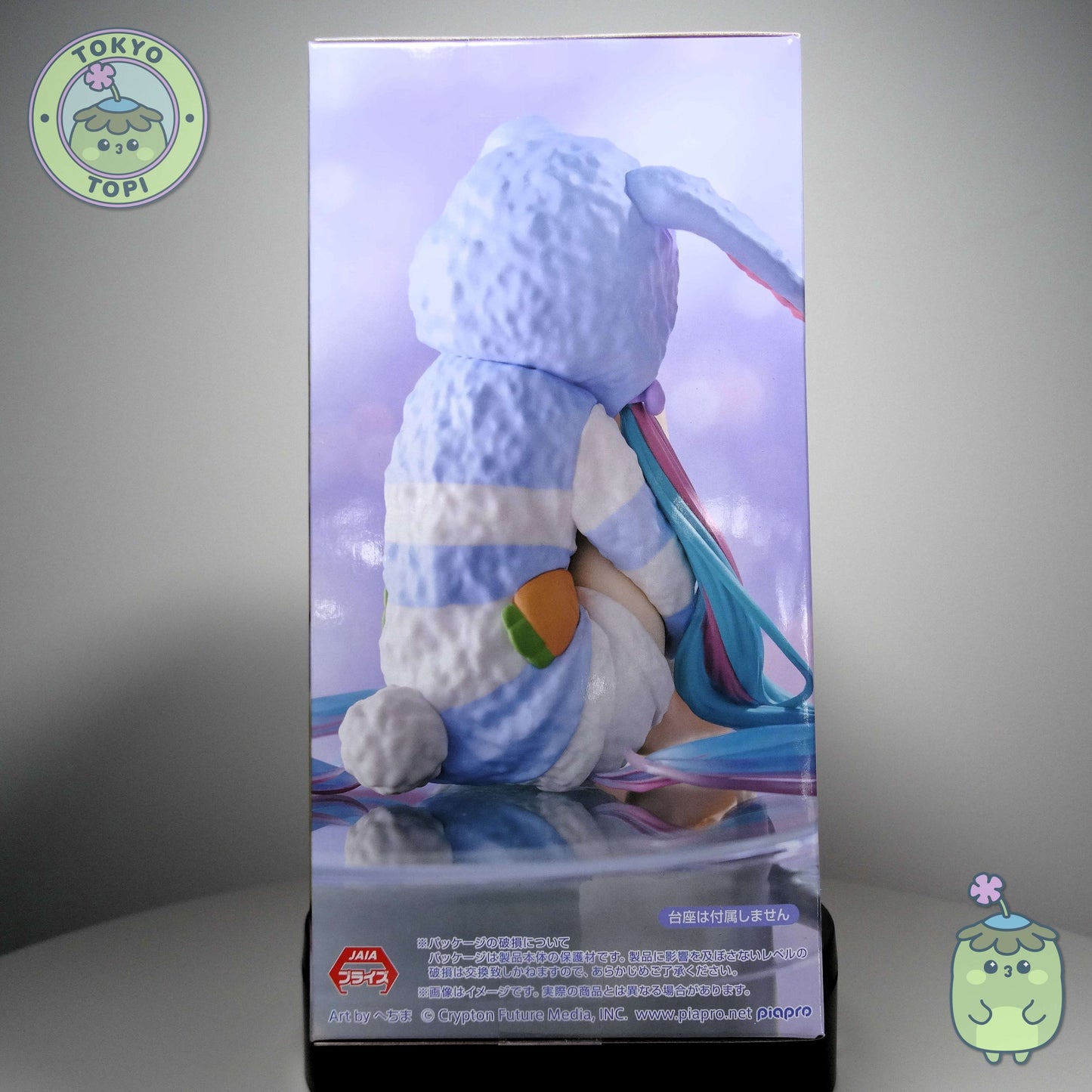 This officially licensed FuRyu figure captures Miku in charming bunny-eared pajamas, complete with a plush hooded design. Standing approximately 14 cm tall, the Noodle Stopper is engineered to perch securely on shelves, desks, or display edges, making it an ideal piece for expanding your Vocaloid collection vertically. The blue colourway and meticulous detailing showcase the character's signature aesthetic while maintaining the functional appeal collectors value in this figure format.