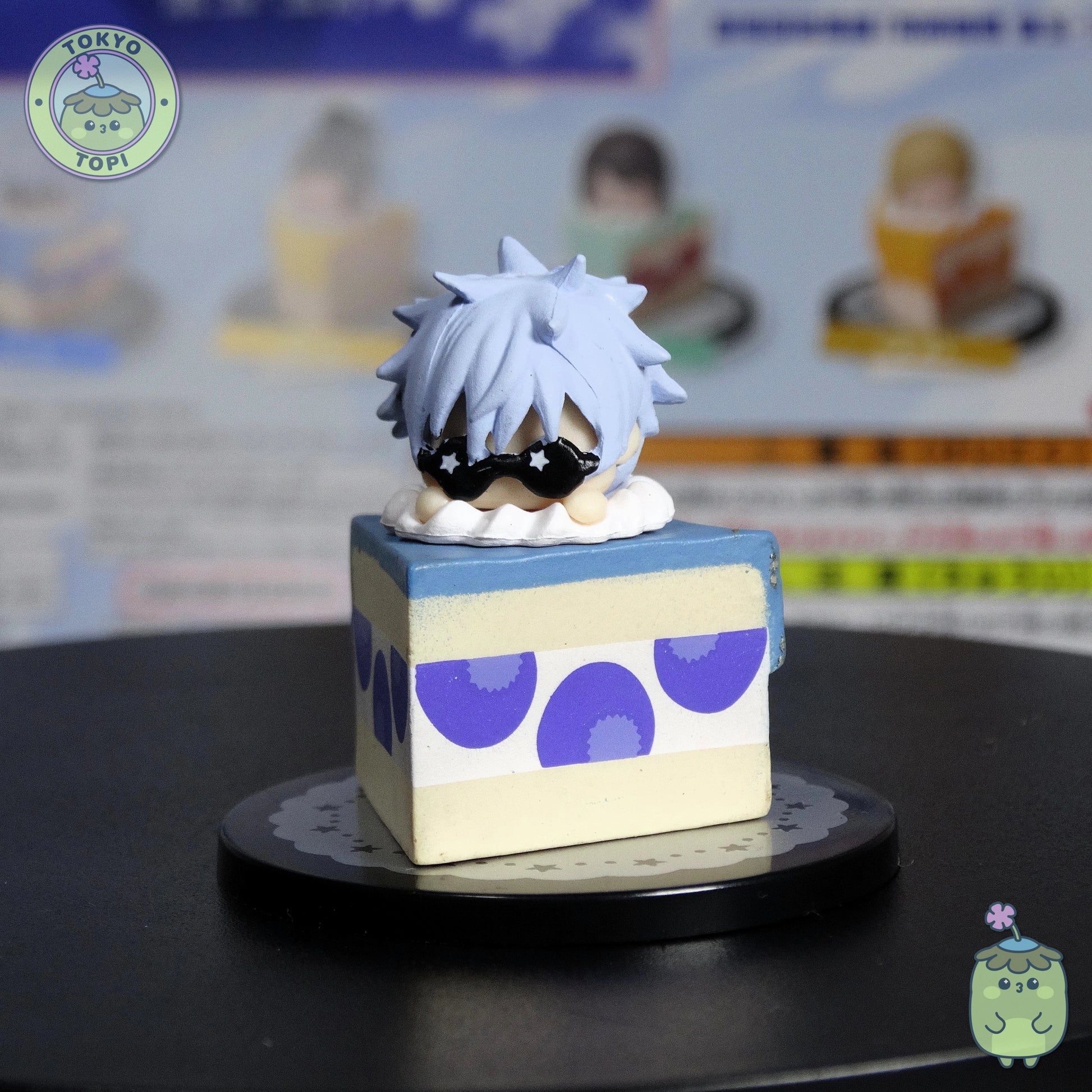 Satoru Gojo Version!

Five beloved characters perch adorably atop their own cake slices—Satoru Gojo, Suguru Geto, Shoko Ieiri, Kento Nanami, and Toji Fushiguro. The best part? Each character's head spins around, letting you pose them however you fancy.

Every figure nestles safely in its own capsule, and you'll get a handy information sheet to complete your collection. Perfect for JJK fans who want their favourite characters displayed with a sweet twist!