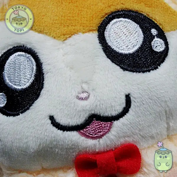 Plush hamster toy with cartoon face in a little bowtie and tiny little hands and feet.