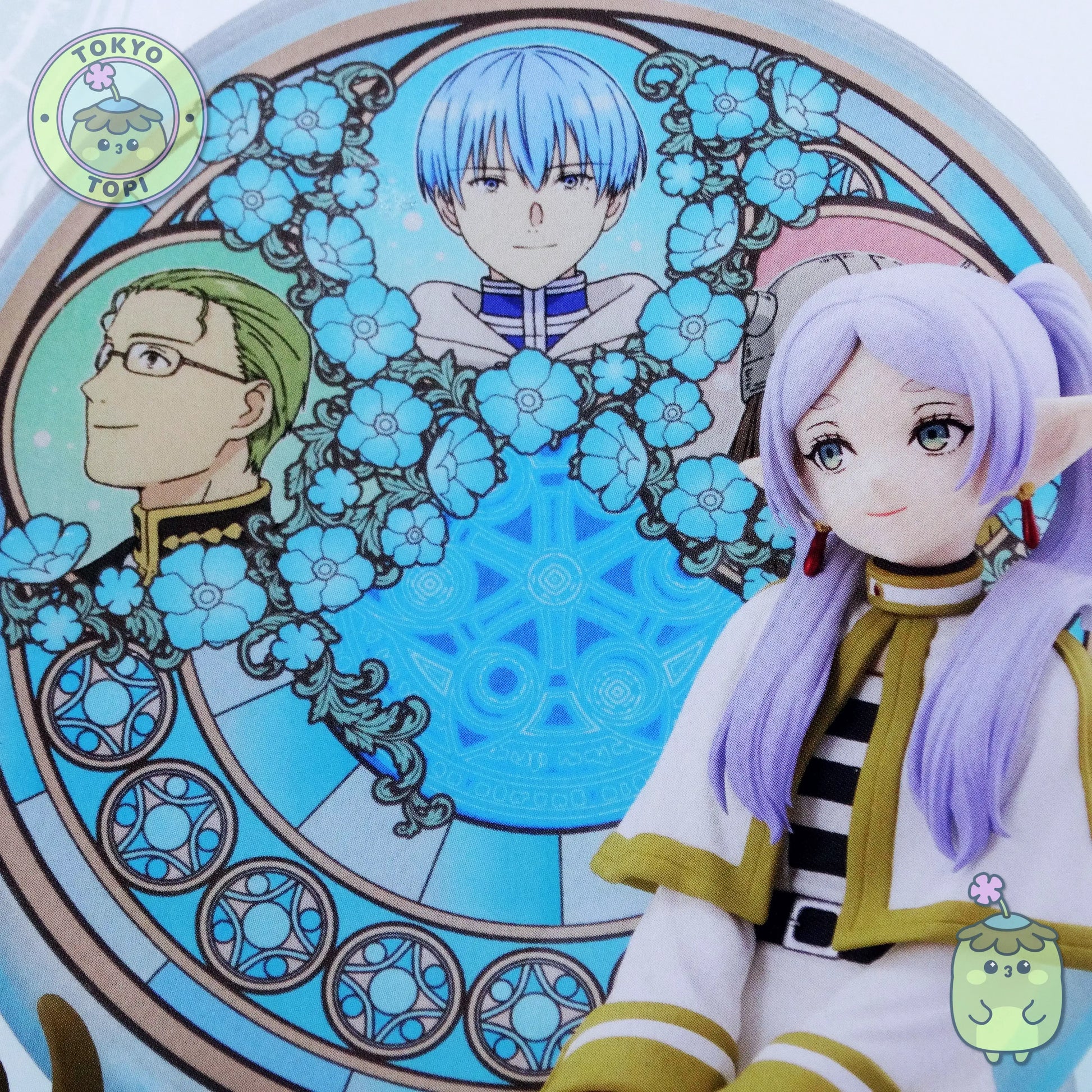 Figure of Frieren from an anime with a stained glass window behind her with other characters from the show including Himmel.