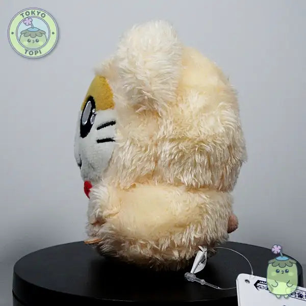 Plush hamster toy with cartoon face in a little bowtie and tiny little hands and feet.