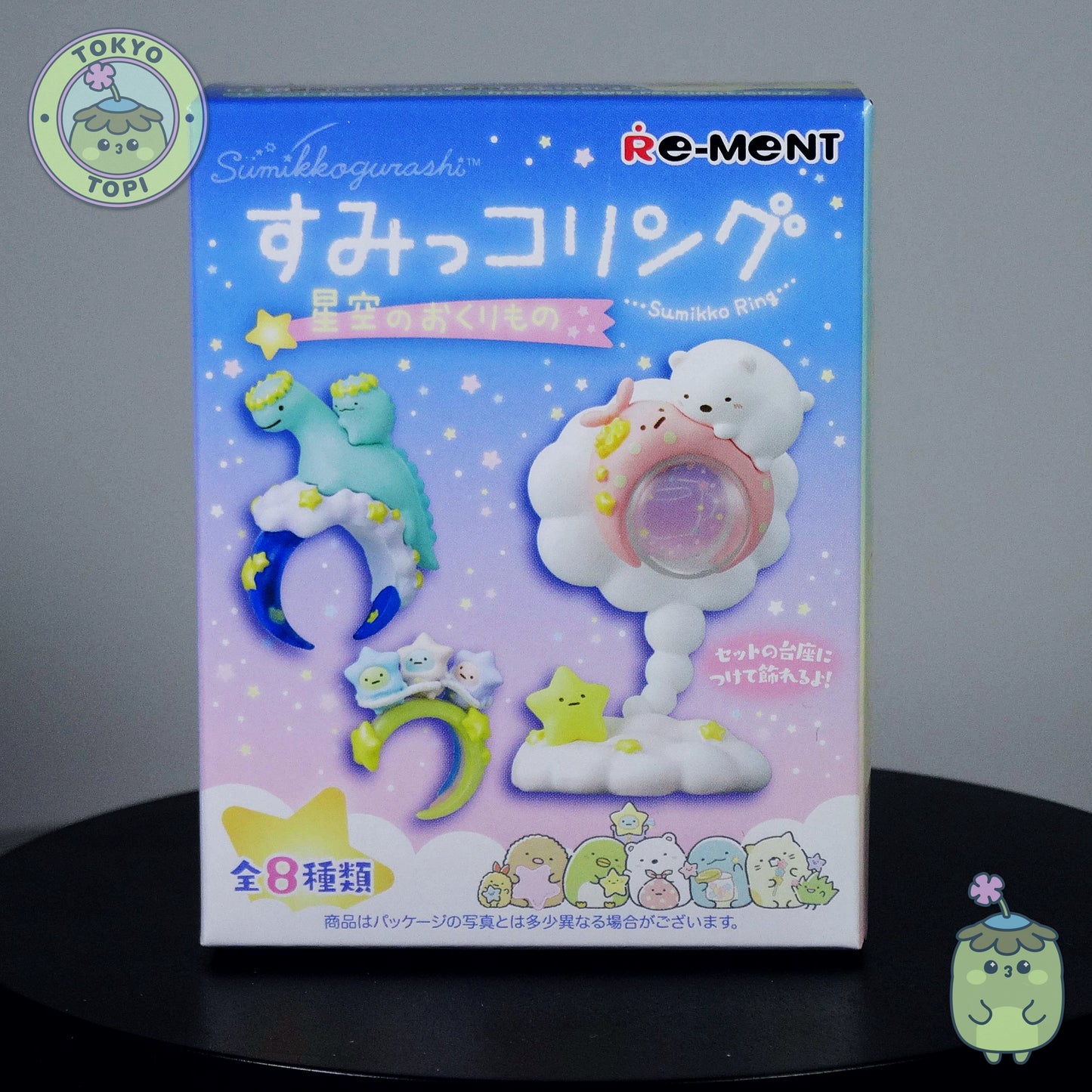 Re-ment miniature packaging with cartoon characters on a dark surface